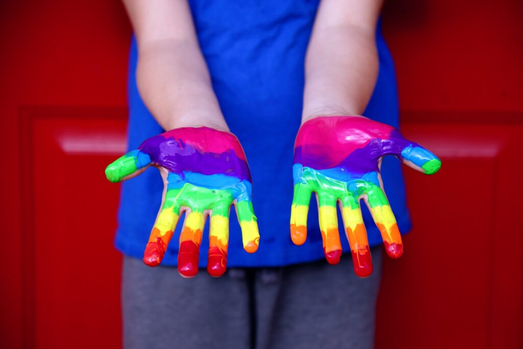 Hands painted as a rainbow