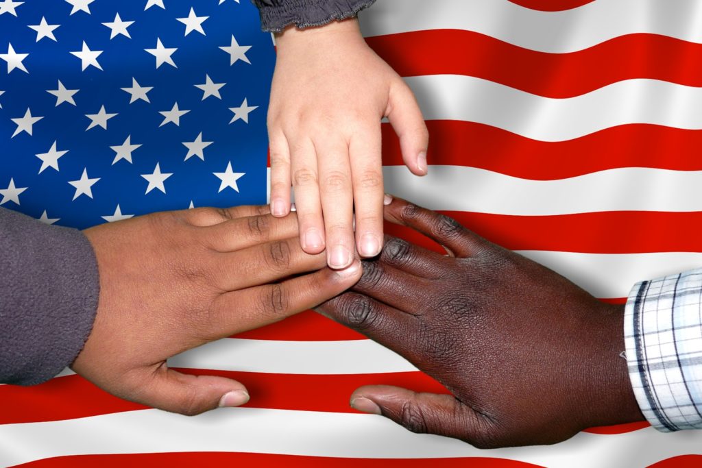 Hands in front of an American flag