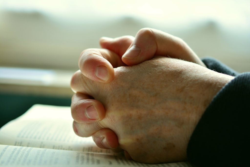 Folded hands in prayer