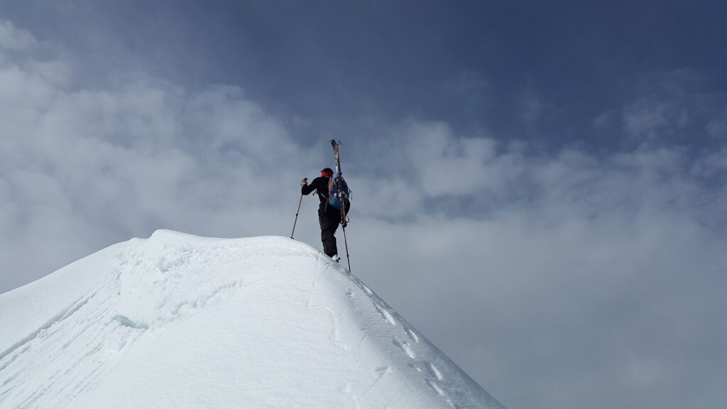 Man climbing snowy mountain