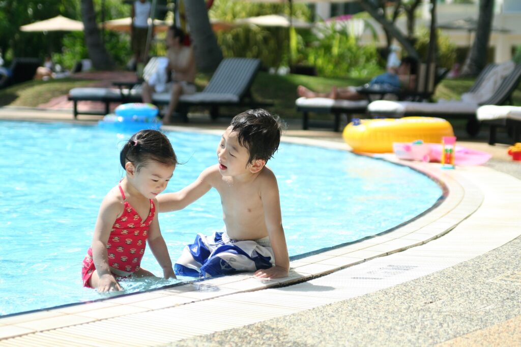 A boy and a girl in a swimming pool