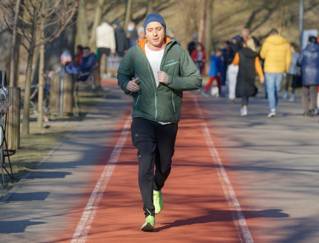 A man running on a track in a park